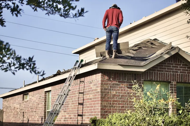 Professional roofer working on a residential roof in Commerce Township